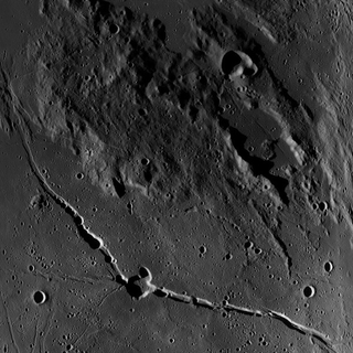 Illustration for article titled Charon Poses a Geomorphic Riddle: How do You Make a Mountain in a Moat?